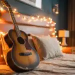 Old Guitar on Bed With Warm String Light