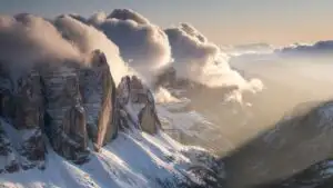 Rolling Clouds Over Snowy Cliffs