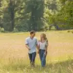 Soft Moment Walking Together in Open Meadow