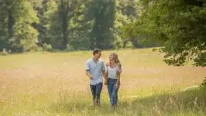 Soft Moment Walking Together in Open Meadow
