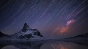 Star Trails Over Mountain Lake at Night