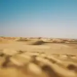 Vast Desert Under Clear Blue Sky