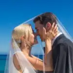 Wedding Couple Kissing Under Veil