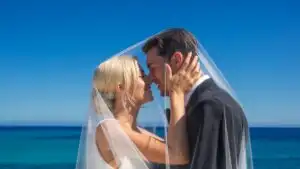 Wedding Couple Kissing Under Veil
