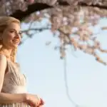 Woman Standing Under Cherry Blossom Tree