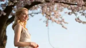 Woman Standing Under Cherry Blossom Tree