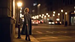 Woman Standing Under Streetlight at Night