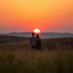 Couple Standing in Field at Dusk