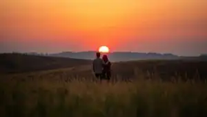 Couple Standing in Field at Dusk