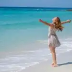Girl Enjoying the Wind on the Beach