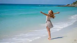 Girl Enjoying the Wind on the Beach