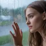 Girl Touching Rainy Window in Soft Evening Light