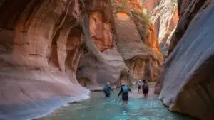 Hikers Walking Through Zion Narrows Canyon River