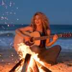 Shakira Singing Beside a Bonfire on the Beach
