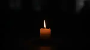 Single Candle in Dark Room