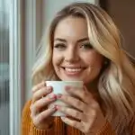 Smiling Woman Enjoying Coffee by the Window