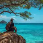 Traveler Sitting on Rock by Ocean