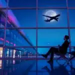 Traveler Watching Airplanes from Terminal