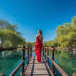 Woman Standing on Wooden Bridge Over River