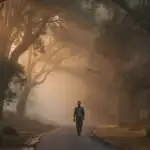 Man Walking Alone in Morning Mist