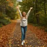 Woman Standing on Path Covered with Leaves