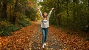 Woman Standing on Path Covered with Leaves