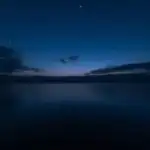 Still Water Under Dark Sky
