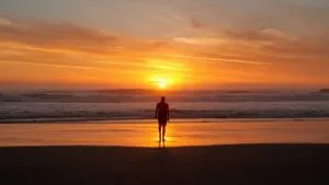 Alone at Sunset Beach Waves Crashing