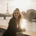 Ariana Grande Smiling on a Bridge Over the River Seine
