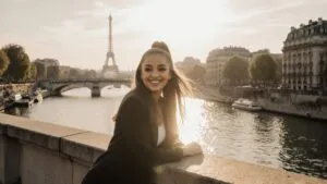 Ariana Grande Smiling on a Bridge Over the River Seine