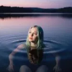Billie Eilish Floating in a Lake at Twilight