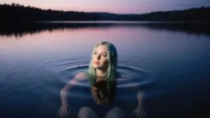 Billie Eilish Floating in a Lake at Twilight