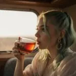 Billie Eilish sipping tea in a vintage camper