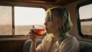 Billie Eilish sipping tea in a vintage camper