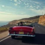 Classic Red Convertible Driving Coastal Highway