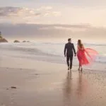 Couple Walking Barefoot on the Beach