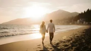 Couple Walking on the Beach at Sunrise