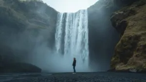 Girl Standing Near Waterfall Mist
