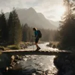 Hiker Crossing Wooden Bridge in Forest