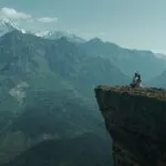 Lovers Sitting on Mountain Cliff