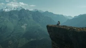 Lovers Sitting on Mountain Cliff