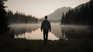 Man Walking Through Misty Forest