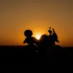 Motorcycle Silhouetted Against a Desert Sunset
