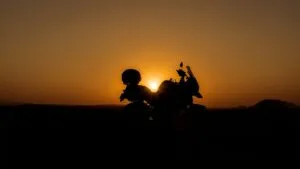 Motorcycle Silhouetted Against a Desert Sunset