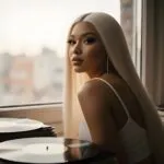 Nicki Minaj Sitting Beside a Window With Vinyl Records