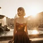 Taylor Swift Standing Beside a Fountain in Rome at Sunset