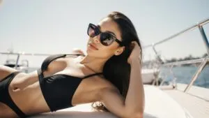 Zendaya lounging on a yacht deck with sunglasses